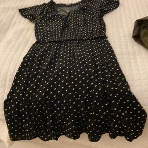 Black polkadot cap sleeve dress to the knees